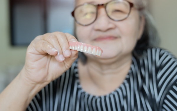 How To Take Care Of Your Oral Health At Home With Implant Supported Dentures